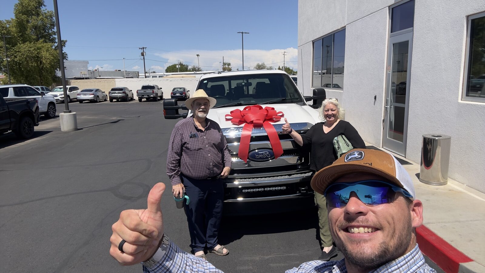 Charlie with a happy couple and their new truck
