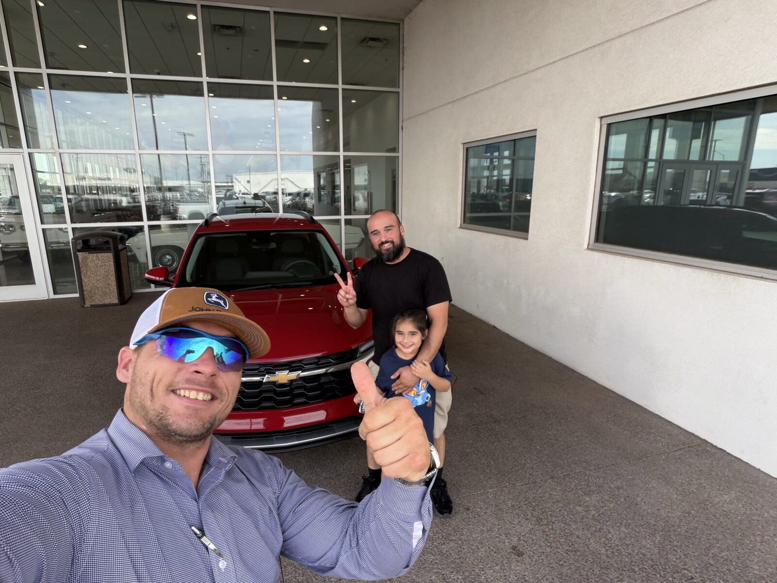 Dad and daughter with their new red Chevy